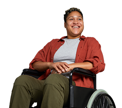 A black woman with a disability smiling in a wheel chair.