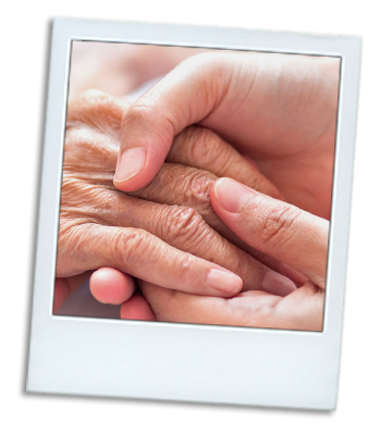 Photo of a young woman hand holding the hand of an elderly woman.