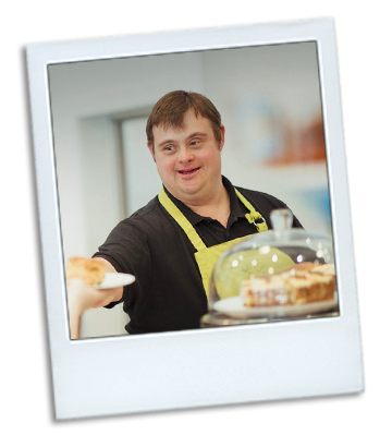 A Polaroid photo of a young man with a disability working in a bakery.