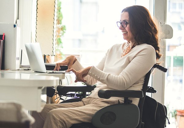 A woman with a disability working at her desk.