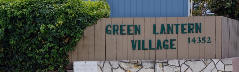 Photo of the front of the mobile home park showing a sign that says Green Lantern Village