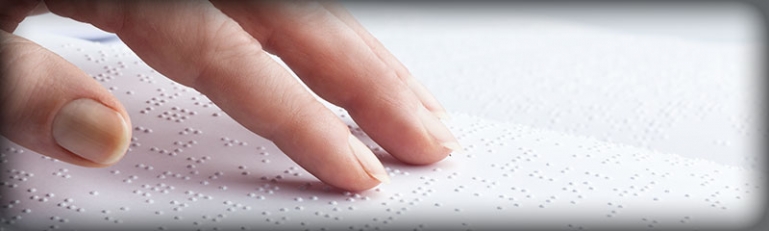 Closeup on the hand of a blind person reading a braille document