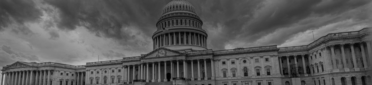 A dark black and white photo of the US capital building.