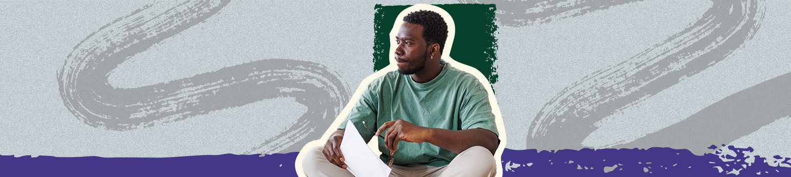 A Black man with an eviction notice in his hands looking distraught. 