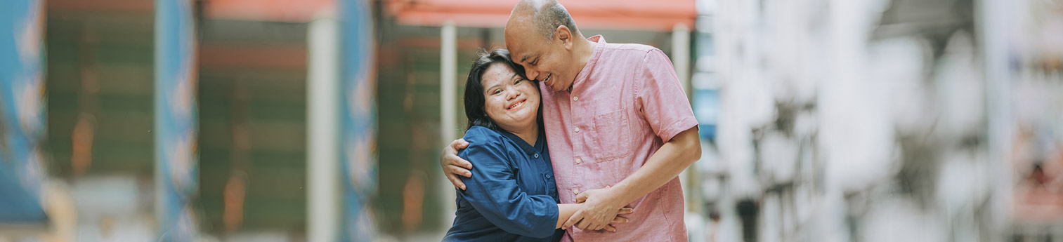 A father holding his daughter who has a mental disability.