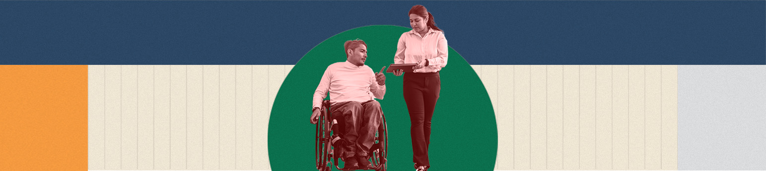 A Latino in a wheelchair with dark short hair, talking with a Latina coworker who has her hair tied up with a tablet in her hands, both are in work clothes.