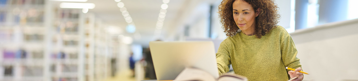 A woman doing research on her computer.