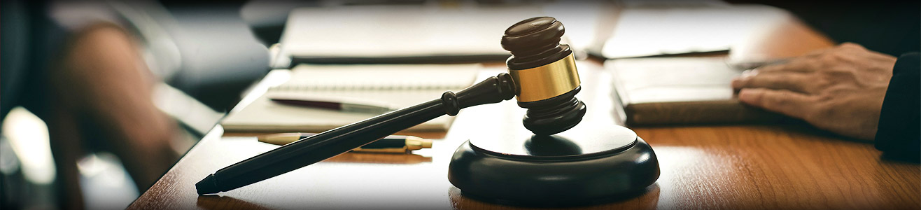 Close up image of a gavel sitting on a judges desk.