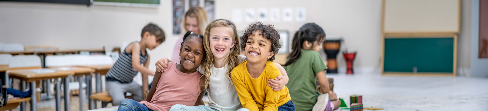 Children smiling together in the class room.