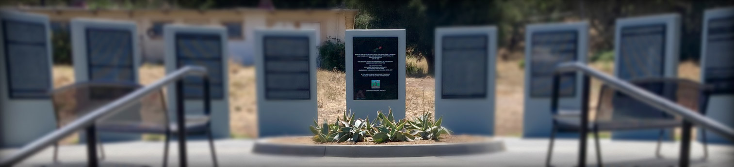 A memorial showing 9 large vertical slabs of stone. They have the names of all those who dies at the location engraved in them.