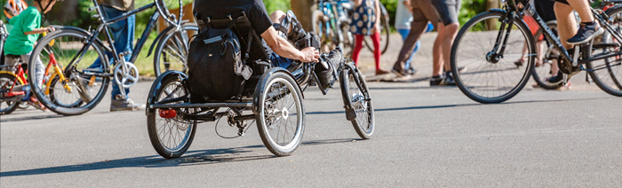 Disabled cyclist on the special handbike bicycle