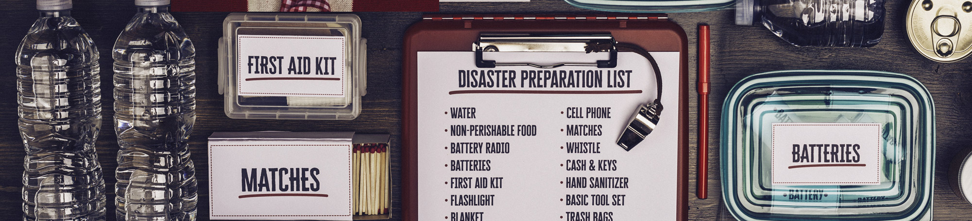 Image showing a disaster planning list and misc items on the list. Bottled water, matches, etc.
