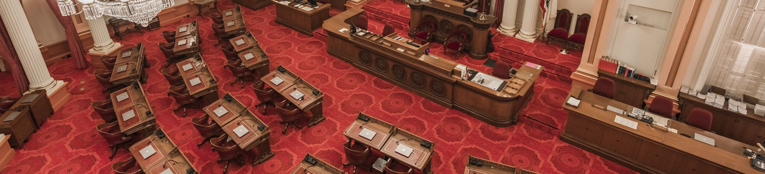 Empty Senate Assembly room located in the historical California State Capitol building.