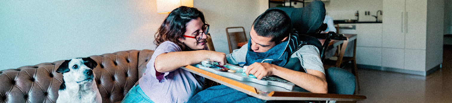 Sister and wheelchair brother with mental illness having fun at home