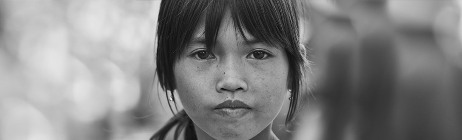 A close up image of the face of a young immigrant girl.