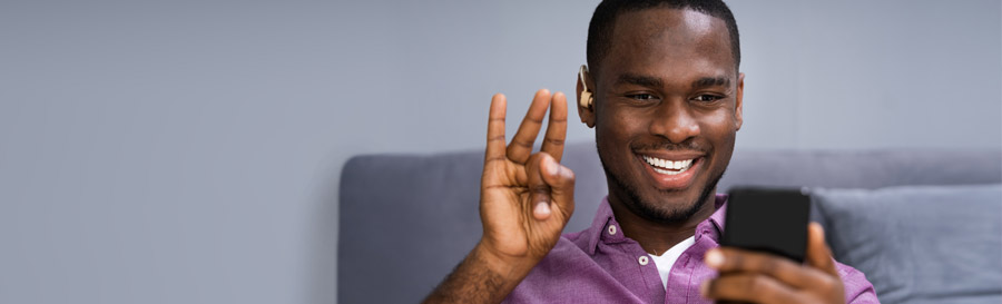 A young man using ASL.