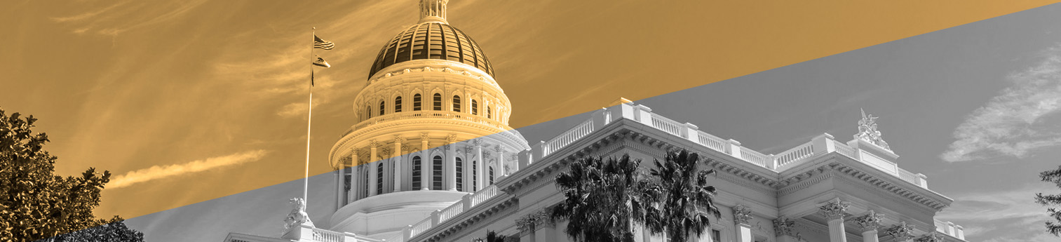 Front of CA State capital. Half of image is yellow and other half black and white.