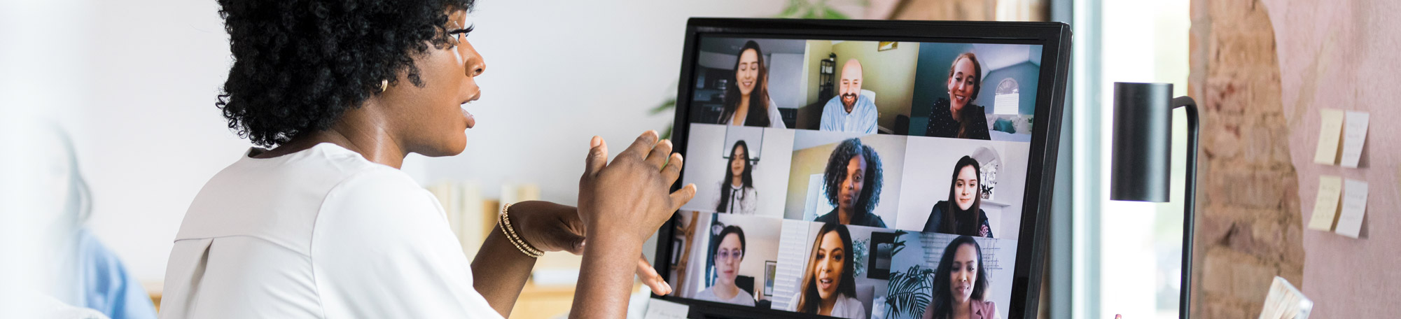 A photo of an African American woman on a video conference.