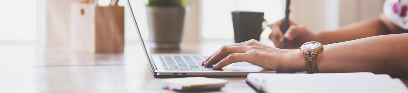 Close up of a woman on her laptop.