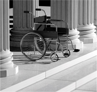 Photo of a empty wheelchair at the steps of the capitol building.