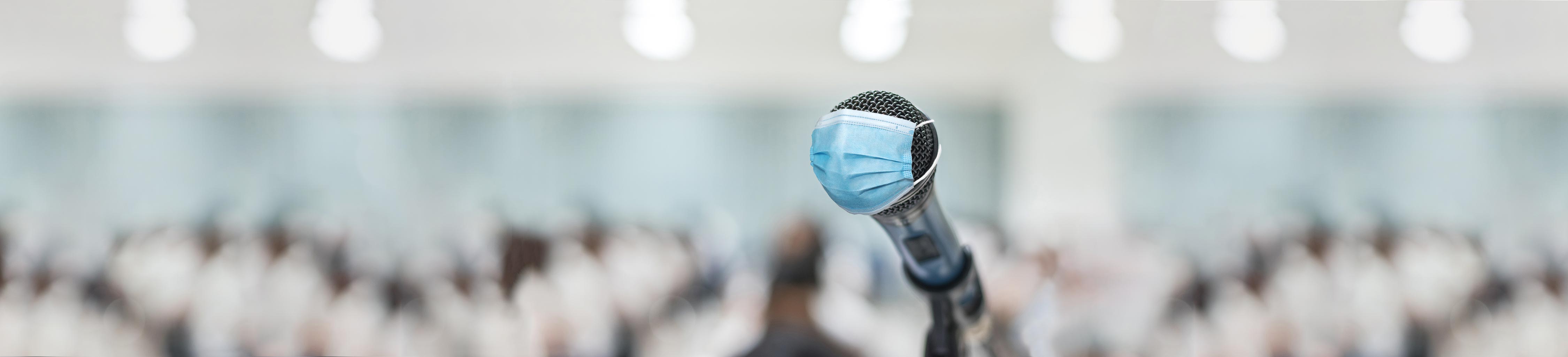 Image of a microphone with a mask covering it.