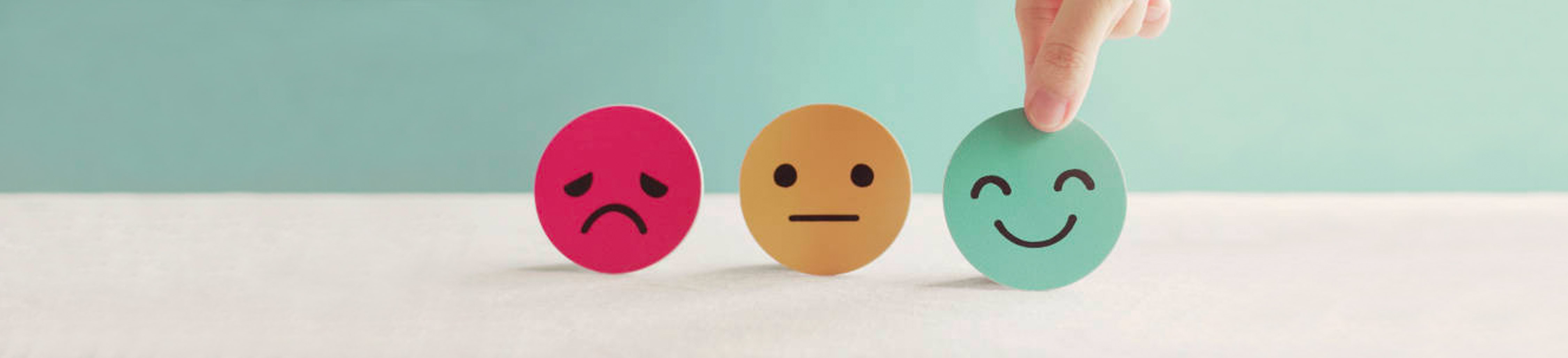 Image of coins with a Happy, Indifferent and Sad Face on them.