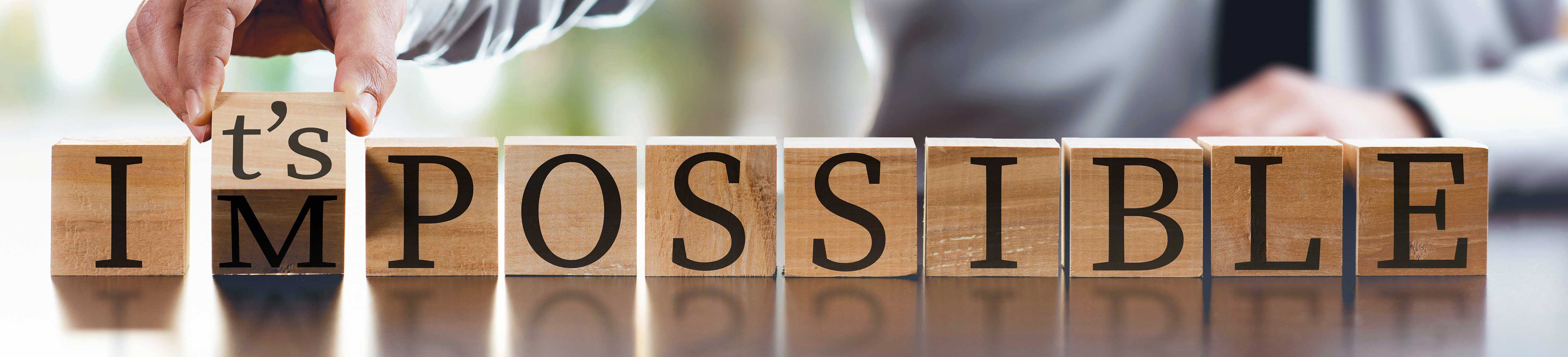 Wood blocks spelling out It's Possible.