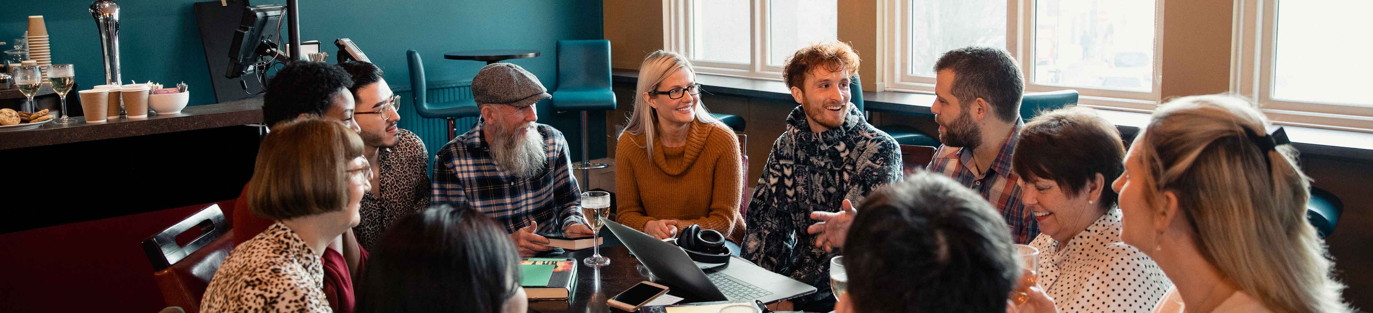 Group of people having a discussion at a table.