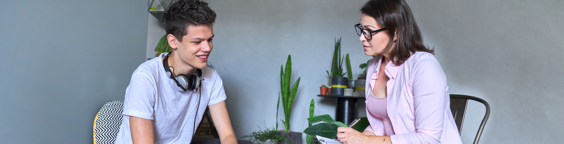 A young man at home getting mental health treatment from a provider.