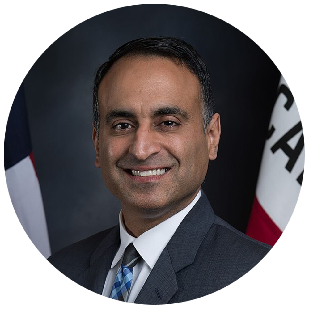 Assemblymember Ash Kalra, an American politician wearing a black suit and blue striped tie.