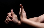 close up of a womens hands while she is using sign language.