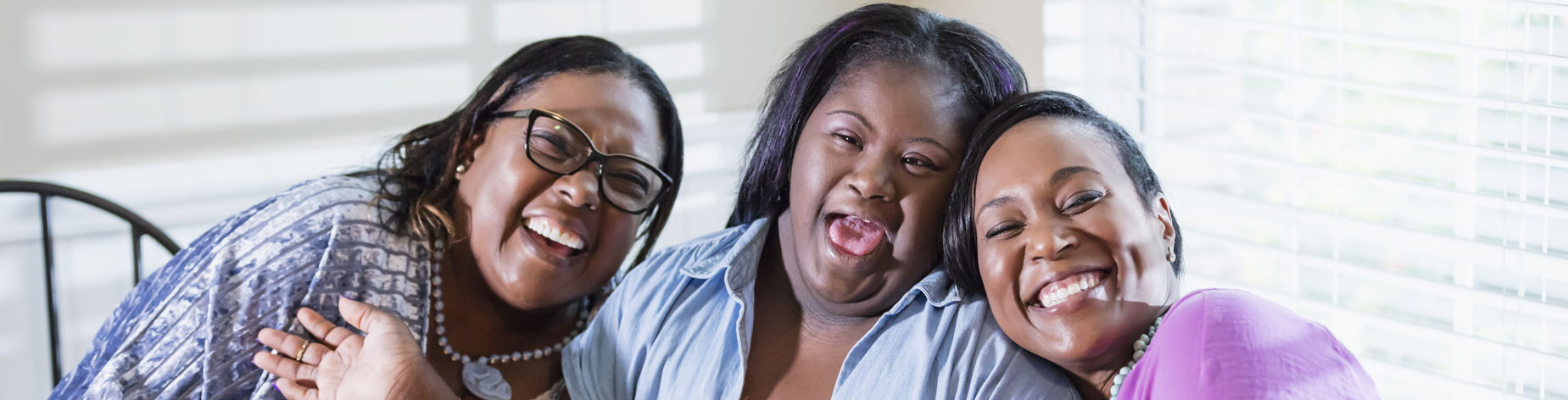 Image of mother and daughter smiling. The daughter has a mental disability.