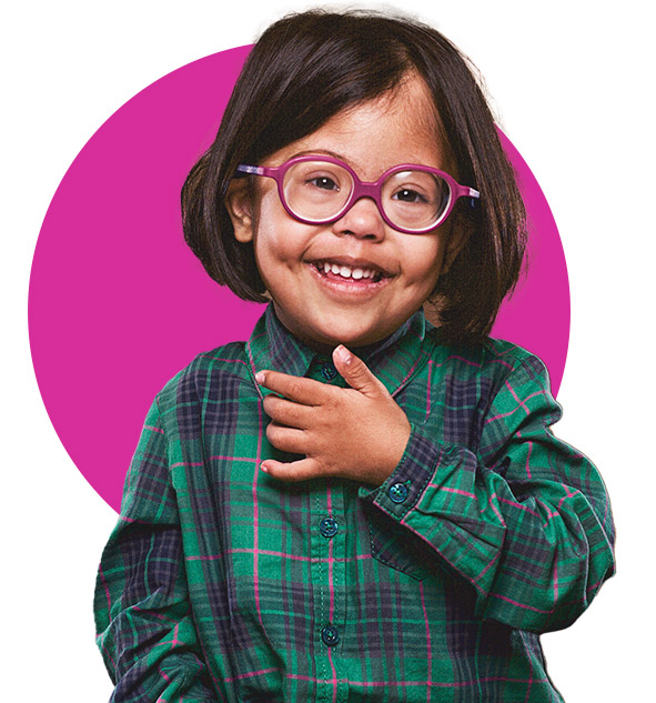 A young child with a disability smiling.