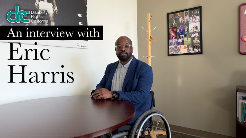 An Interview with Eric Harris Video Title Screen. He is a black man and wheelchair user. He is sitting behind a desk in his office.