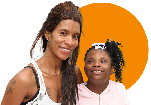 Photo of a black mother with her daughter who has a disability. They are both smiling