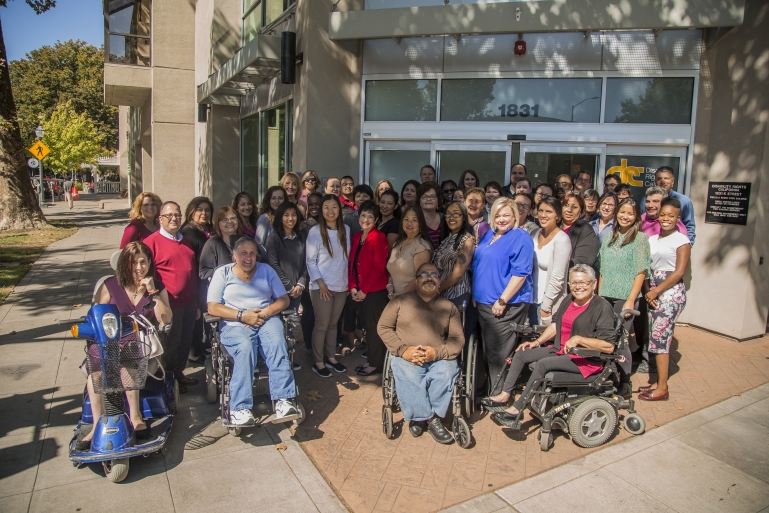 Photo of a large crowd of DRC staff members posing in front of the Sacramento office.