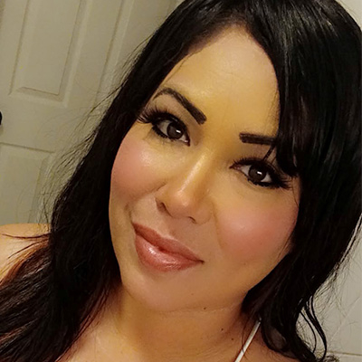 A portrait photo of Aurelia Sanchez, she has fair skin with medium length hair.