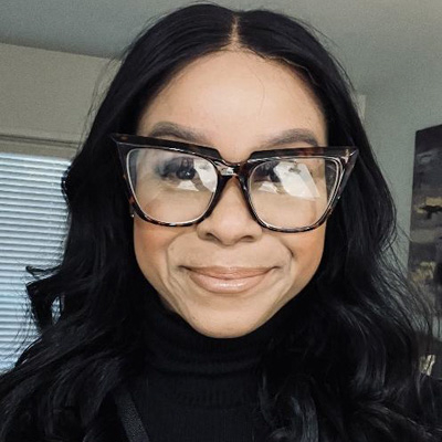 A portrait photo of Valerie M. Williams, she has fair skin with medium length hair and wears glasses.