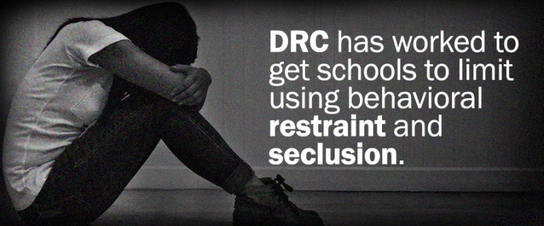 DRC has worked to get schools to limit using behavioral restraint and seclusion. - Photo of a young girl sitting alone in a room with her face in knees.