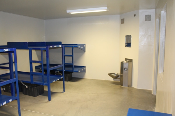 A bare room showing blue metal frames of bunk beds