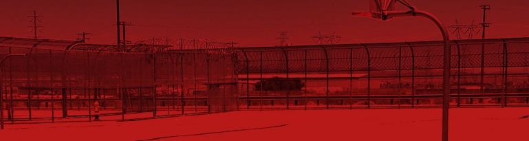 The outsite recreation are. It is bare and has fences all around it. the image is tinted in red.