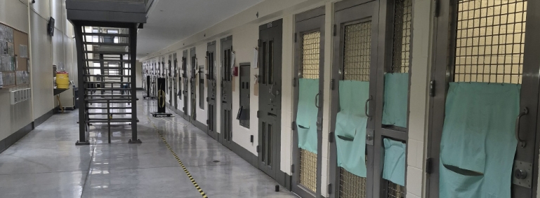 Posterior Segregation Unit showing a long hallway with cell doors along one side