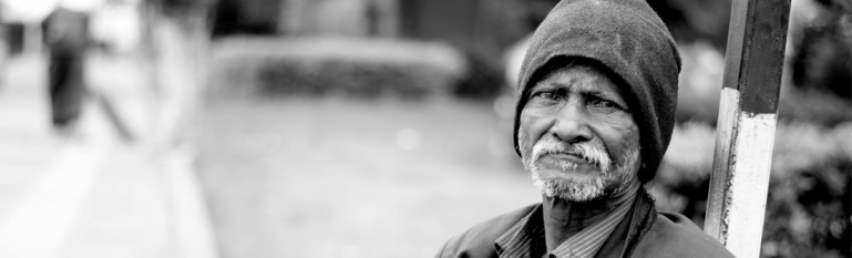 Close-up photo of a elderly mans face. He has a worried look on his face.