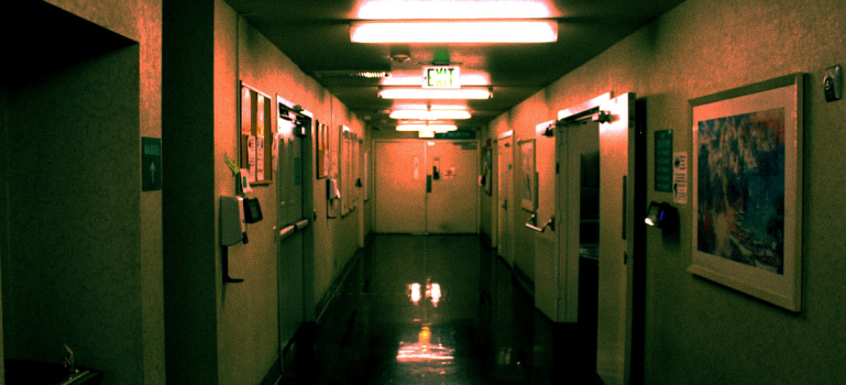 The water fountain hallway of inside college, with hues of greens and orange