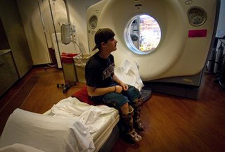 Photo of Derek waiting to go through a medical diagnostic machine.