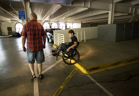 Derek expertly handling a curb while on his wheelchair.