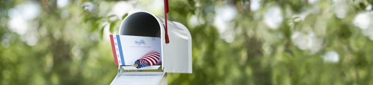 Mailbox with voting ballot ready for pickup.