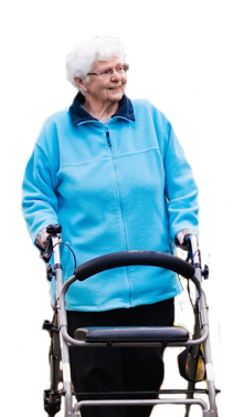 Photo of an elder woman having a stroll in the park with the assistance of a walker.