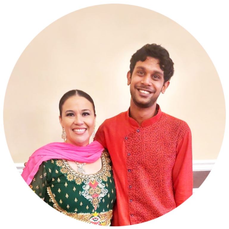 Vanessa Ochoa and Neil Chand smiling while posing for a photo.