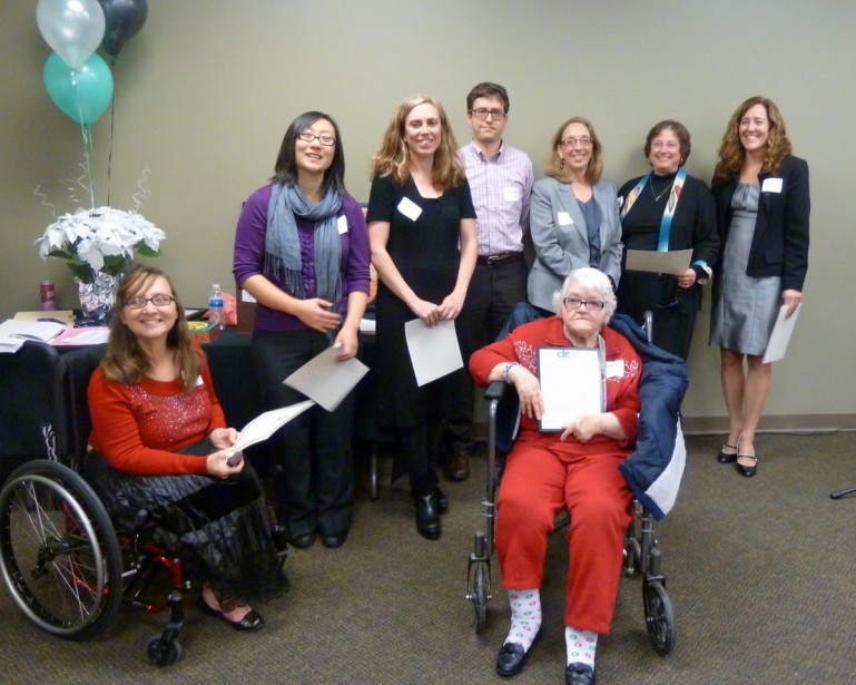 Photo of Esther Darling receiving a client award with her legal team besides her.